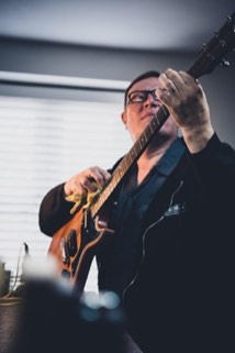 John working on a guitar